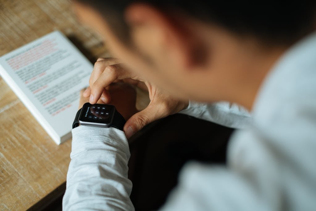 Man in White Dress Shirt Using Black Smart Watch